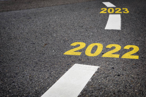istock 2022 to 2023 on black asphalt road and white marking lines 1324236049