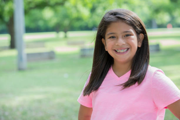Preteen girl smiling while outdoors at the park