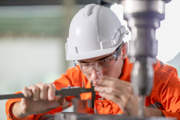 istock Quality Control Engineer measuring a mechanical material part production by calipers in factory. 1324237447