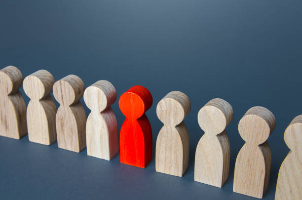istock Red man in a crowd. Stranger, eye-catching. Different, special. Infected carrying threat of pandemic spread. Intruder detection. Coming out. Be different. Collective immunity. Social distance. 1324237578