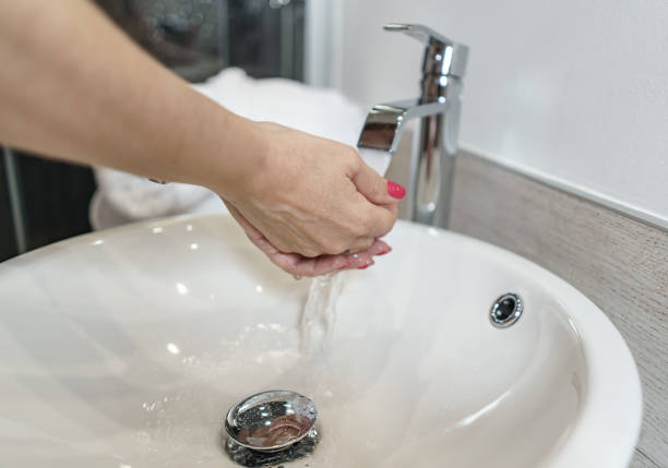 istock Woman washing her hands in a hotel bathroom. 1324237643