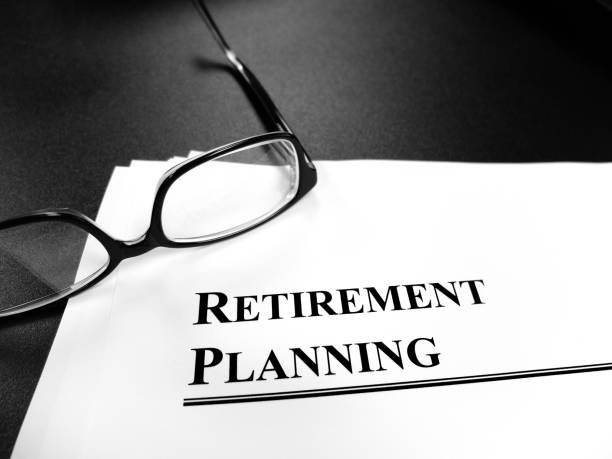 istock Retirement planning documents on desk with glasses for plan to retire 1324240180