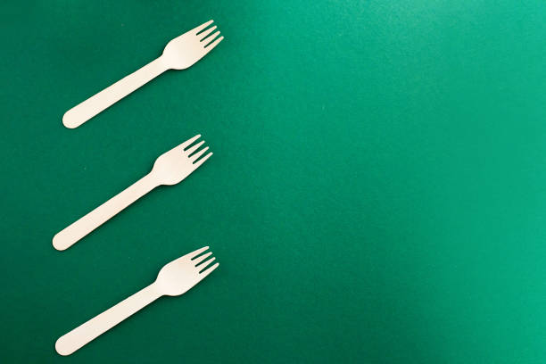 istock Eco friendly disposable dishes on green background. Sustainable lifestyle concept. zero waste, plastic free, stop plastic pollution. 1324242400