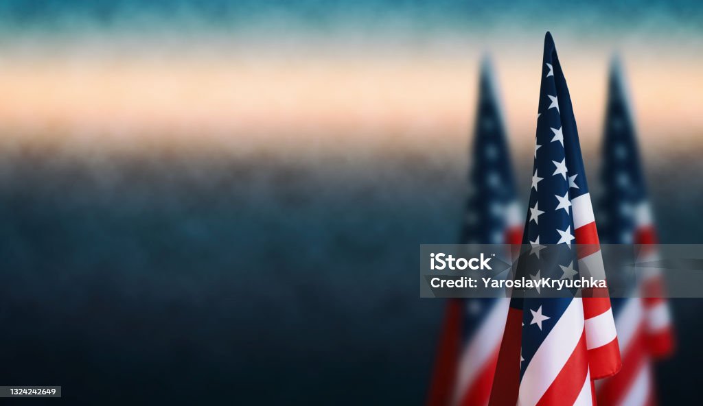 American flags Happy Veterans Day, Labour Day, Independence Day. Happy Veterans Day background, American flags against a blue fog background, November 11, American flag Memorial Day, 4th of July, Labour Day, Independence Day. US Veteran's Day Stock Photo
