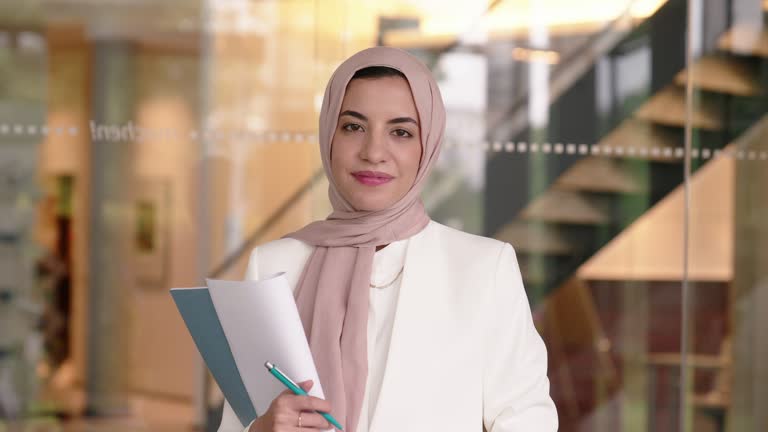 Businesswoman with headscarf holding file