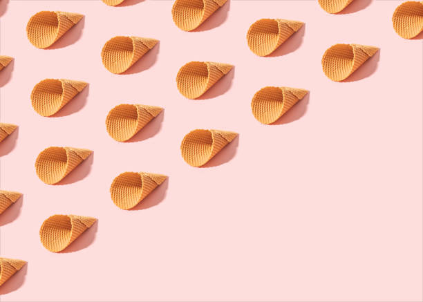 istock Minimal summer pattern made of empty ice cream cones on sunny pink background with diagonal copy space. 1324245670