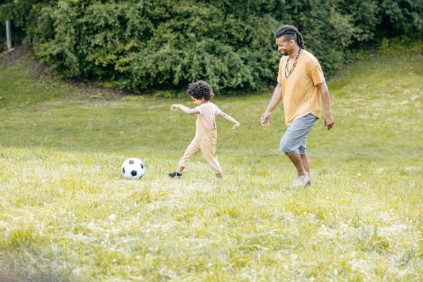 istock Toddler playing soccer with dad outdoor 1324246470