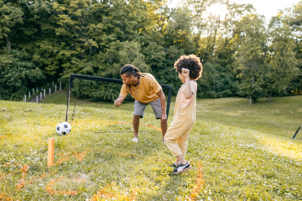 istock Scoring a goal. Dad and son playing soccer  during their day trip together 1324246492