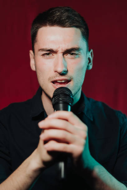 istock Man in leather jacket performing on a dark stage in club 1324247837