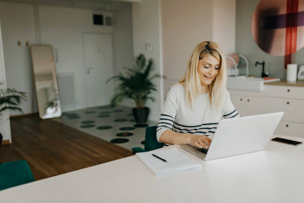 istock Mid adult woman studying from home 1324251928