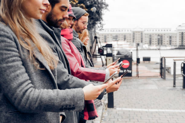istock People using smart mobile phones app. Students addiction to new technology trends. Concept of youth, social and friendship. Focus on first boy - Image 1324252843
