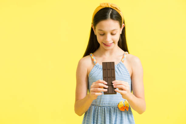 istock I love chocolate. Preteen enjoying a candy 1324253033