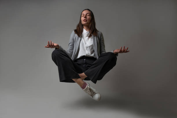 istock Meditation and stress control at work, a young woman in a business suit, 1324254025