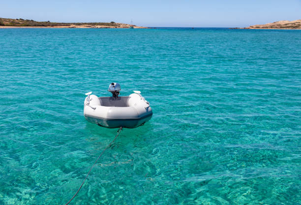 istock Dinghy Inflatable boat on turquoise blue sea water 1324256397