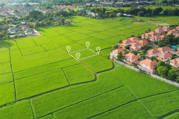 Land or landscape of green field in aerial view. Include agriculture farm, house building in village. That real estate or property. Plot of land for housing subdivision, development, owned, sale, rent, buy or investment in Chiang Mai of Thailand.