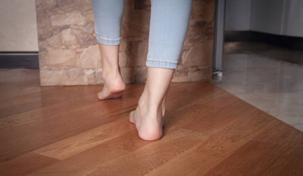 istock Female feet walking on floor at home. 1324258141