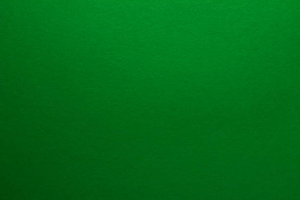 istock Green background. Sheet of blank green paper with texture, close up. 1324259344