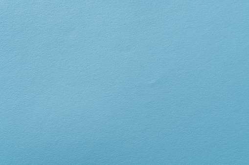 Pastel blue background with fine paper texture.