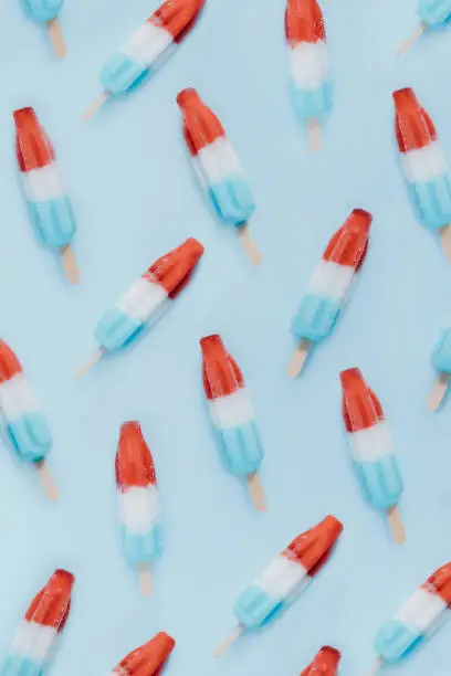 Several popsicles scattered on a blue background.