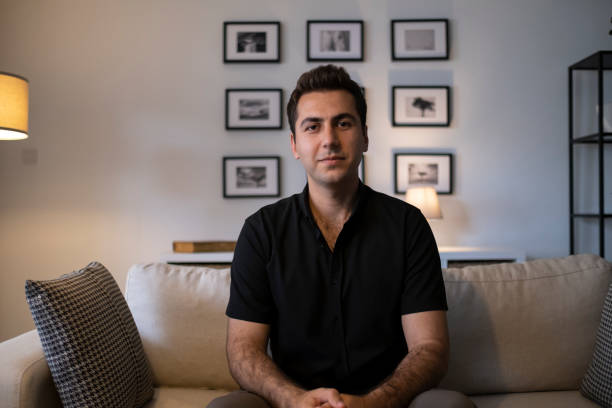 Headshot portrait millennial guy sit on sofa makes video call