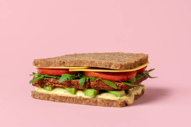 istock Vegan sandwich close-up isolated on a pink background. 1324265684