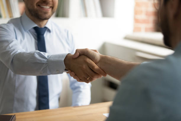 istock Close up happy two business men shaking hands, making agreement. 1324266961