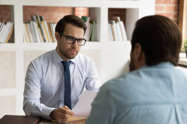 istock Focused hr manager in eyeglasses holding interview with job applicant. 1324266965