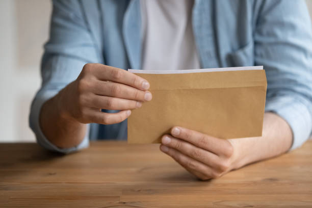 istock Close up young man getting business correspondence in envelope. 1324267925