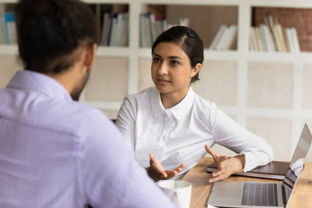 istock Concentrated two mixed race managers discussing online project. 1324267927