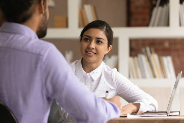 istock Happy young mixed race colleagues discussing business ideas. 1324267930