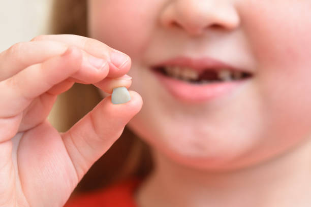 istock Child shows his first baby tooth that has fallen out 1324268053
