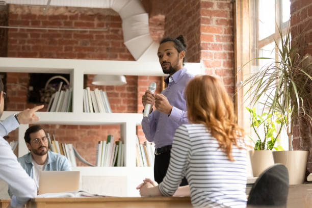 istock Young african american mentor telling speech in modern office. 1324268075
