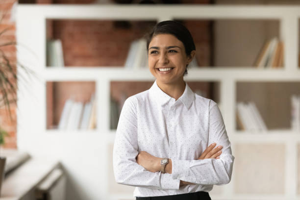 istock Successful happy young indian business lady posing in modern office. 1324268099