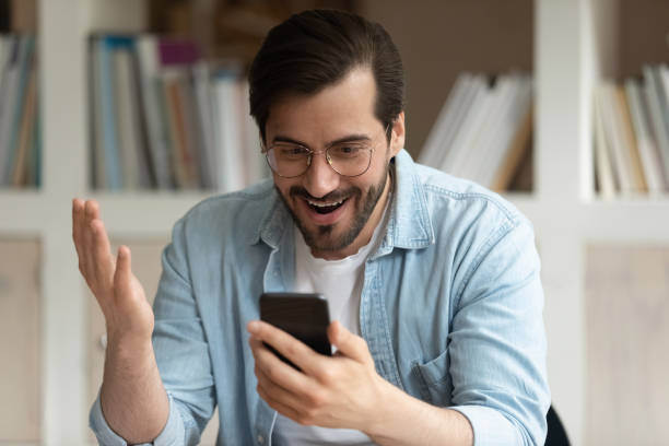 istock Surprised young man getting message with unbelievable news. 1324268362