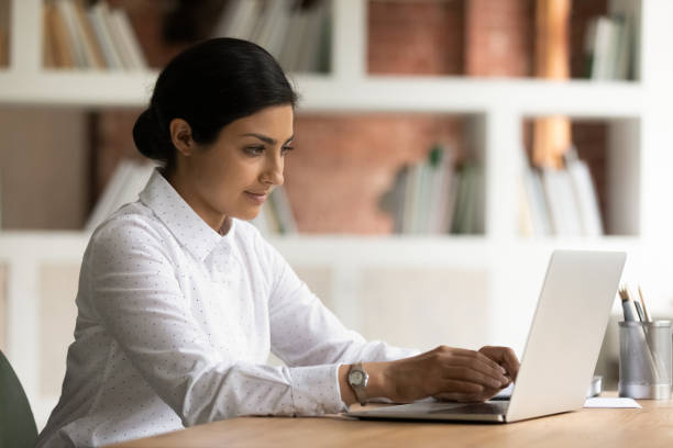 istock Focused young indian ethnicity business lady working on computer. 1324268367