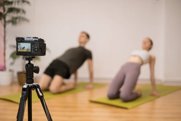 istock Man and woman teaching online yoga classes 1324270172