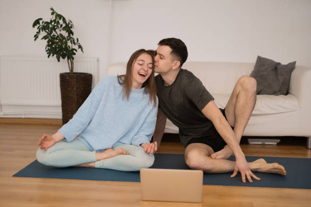 istock Beautiful couple practicing online yoga classes 1324270310