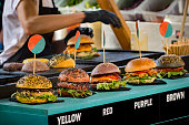 Burgers displayed in a row on street food vendor stall