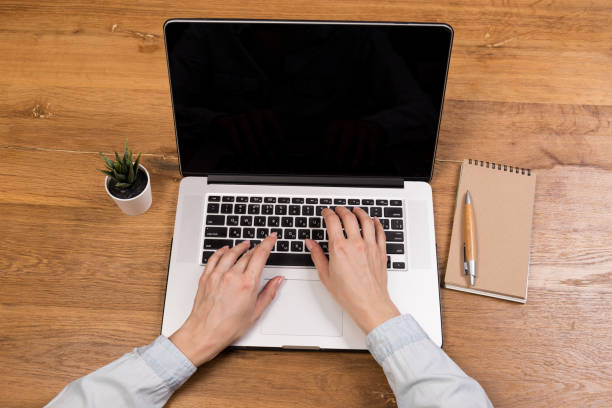 istock Hands close-up. Working on a computer, laptop. Office background. Online work. Typing 1324272654