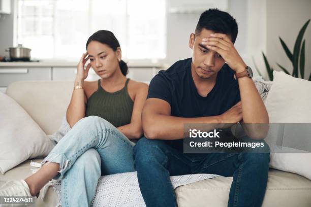 Shot Of A Young Couple Ignoring Each Other After An Argument At Home Stock Photo - Download Image Now
