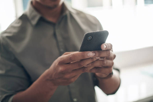 istock Closeup shot of an unrecognisable man using a cellphone at home 1324274755