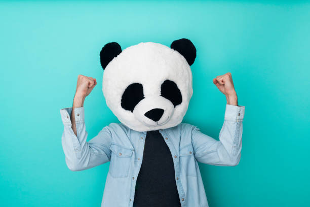 istock Young man wearing panda mask over isolated background doing strong gesture 1324275881
