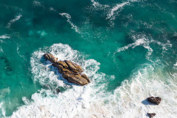 istock Sea foam, turquoise water and rocks 1324276062
