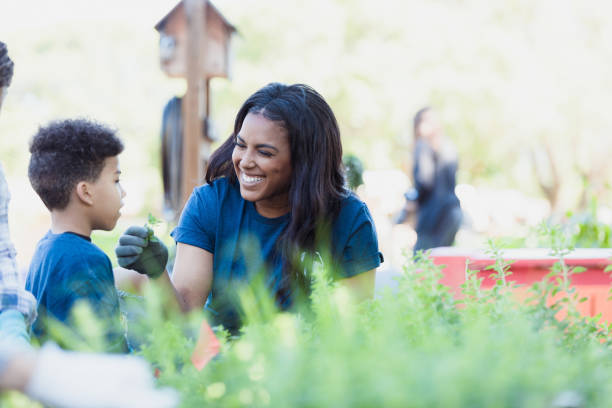 istock Smiling mom holds herb for son to smell 1324276078