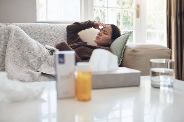 istock Shot of a young woman lying on a sofa while feeling sick at home 1324276156