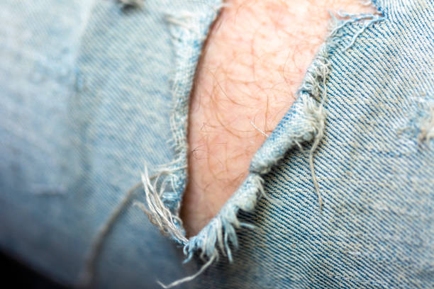 Blue jeans denim background texture. Jeans torn fabric material surface