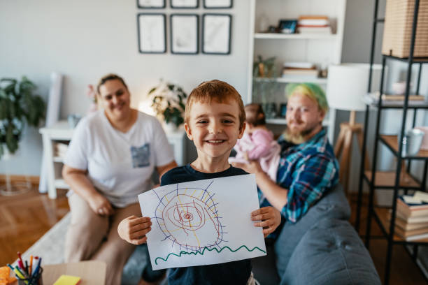 istock Kid showing his drawing and smiling to camera 1324280471