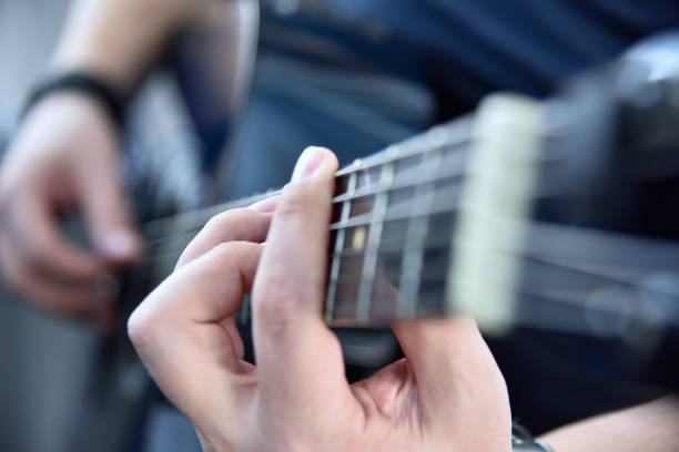 istock Guitarist playing on blue acoustic guitar. 1324282518