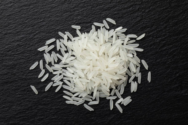 Basmati rice Basmati rice on black background basmati rice stock pictures, royalty-free photos & images