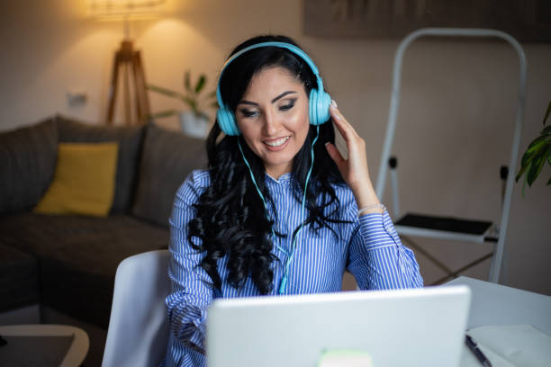 istock Smiling woman in headset have inline educational course stock photo 1324288324